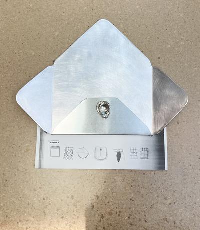 1:25, 2025. Aluminium, sølv, fotokopi. 
